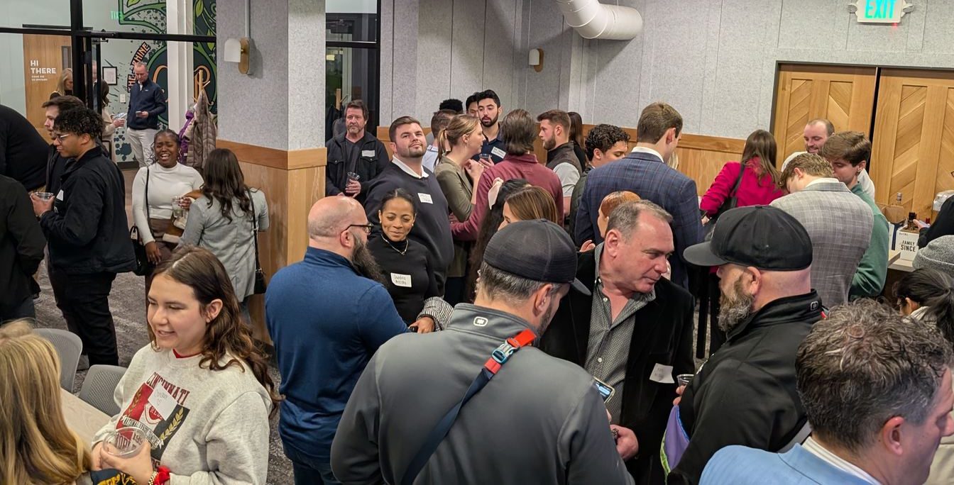 A full room of guests networking at a Connect Cincy mixer at COhatch in Over-the-Rhine, Cincinnati